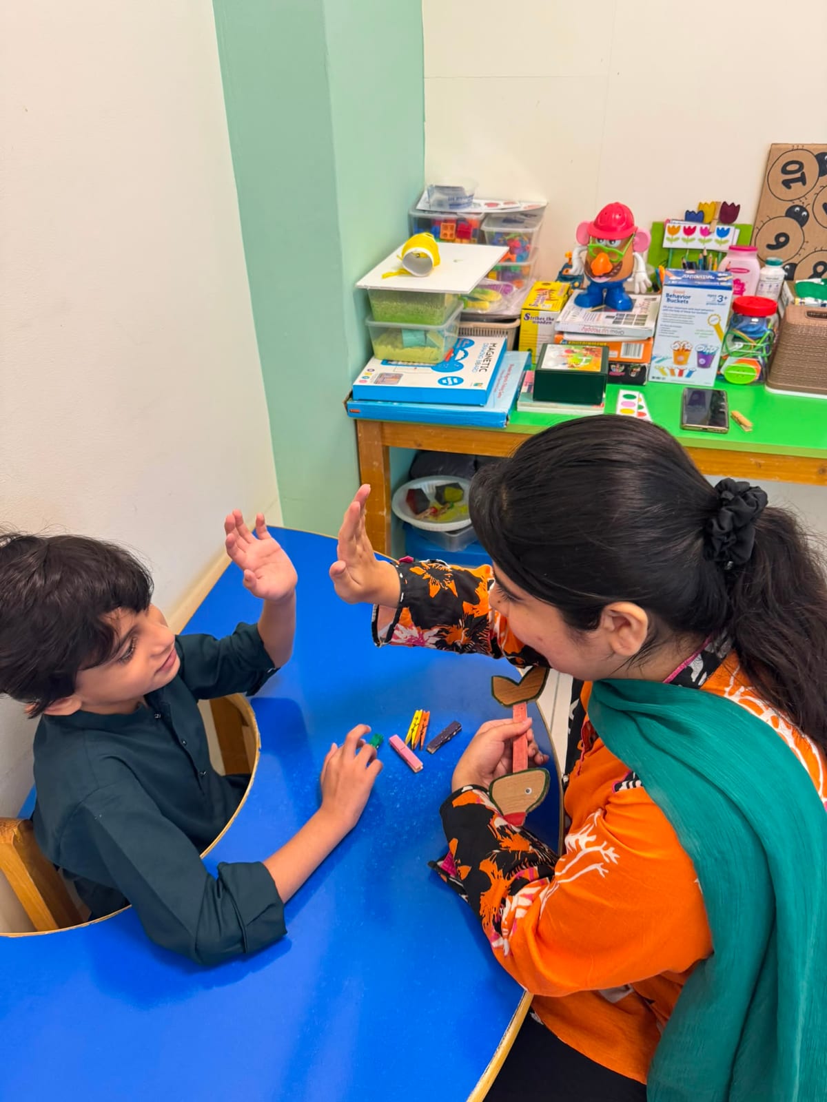 Therapist working with child on floor