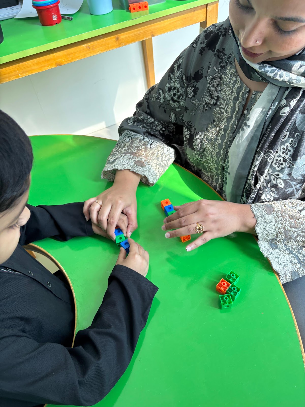 Learning Lab therapist guiding child with learning blocks