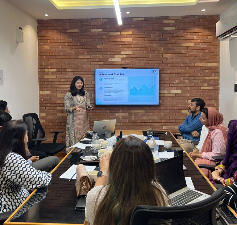 Parents in consultation and multidisciplinary progress review session at Learning Lab