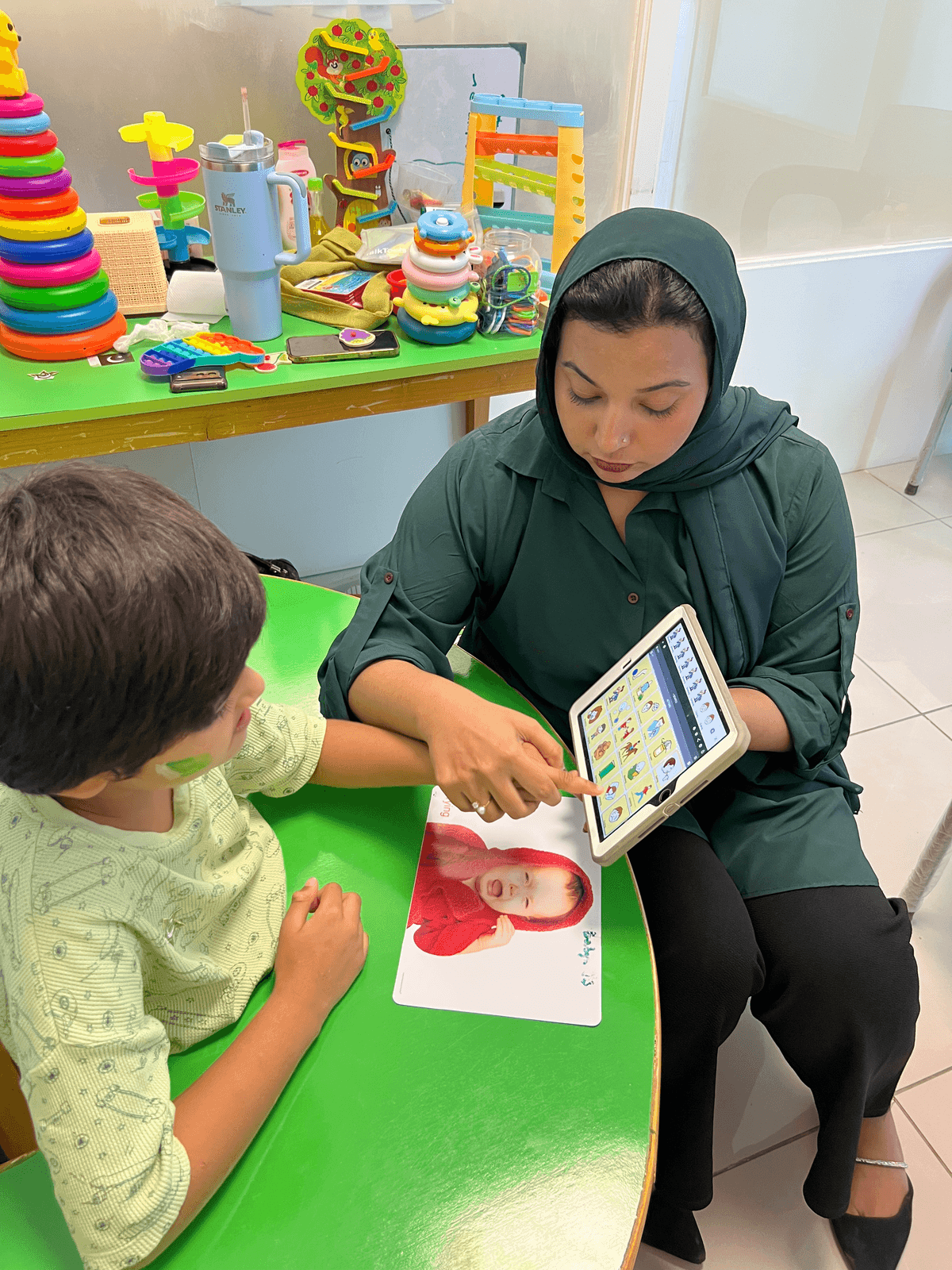 Speech therapist doing mouth exercises with child